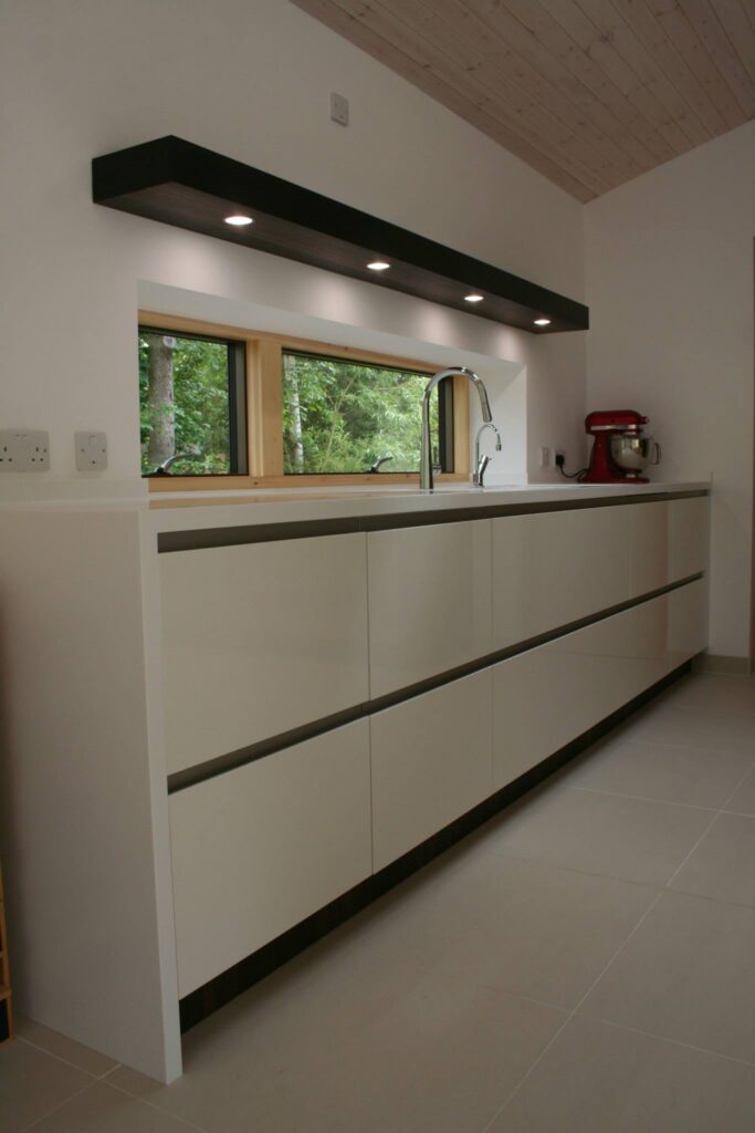 Atmos in high gloss white, with smoked oak — a Rational kitchen by Kitchensmiths (photograph 4 of 4)