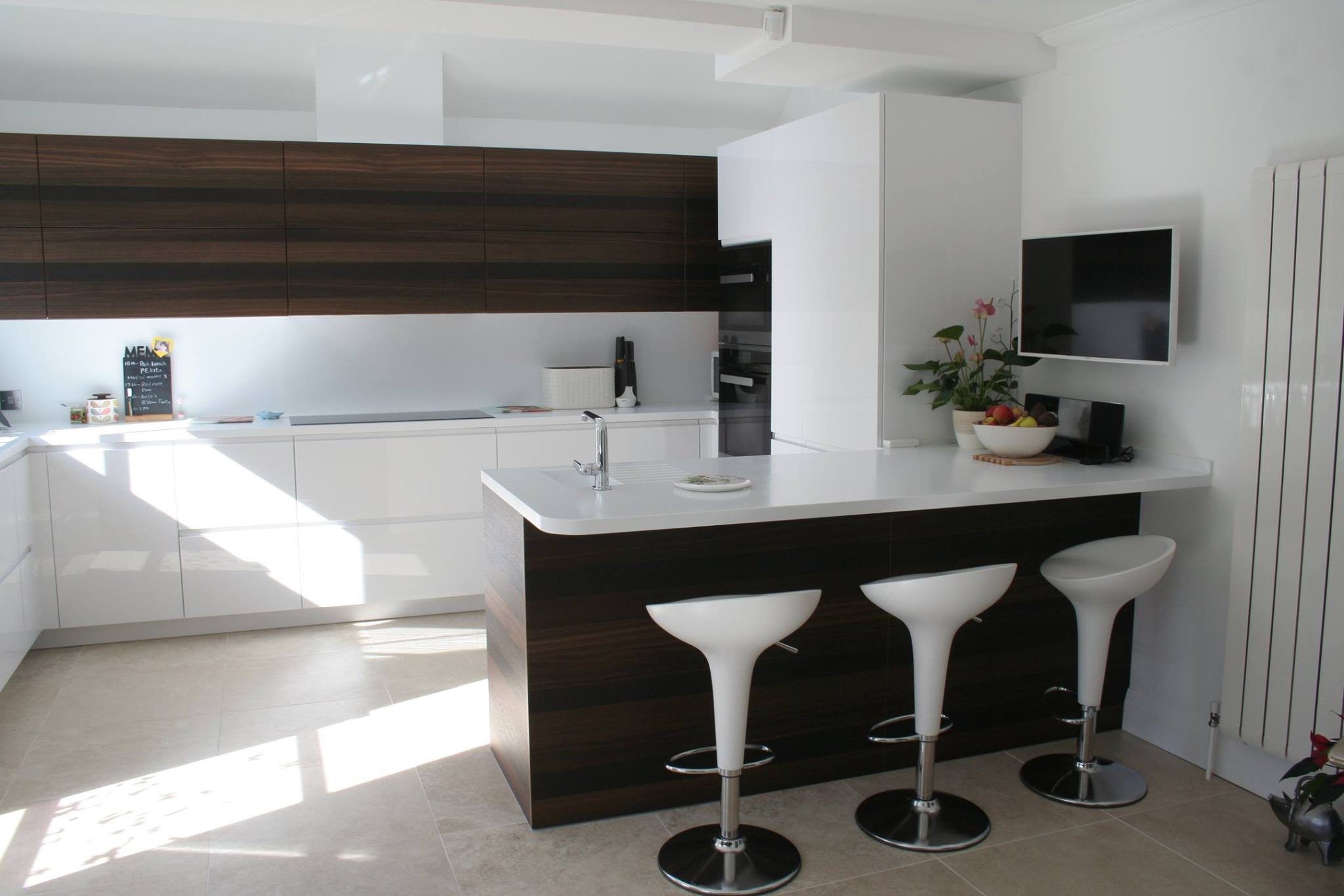 Solo in high gloss white, with smoked oak — a Rational kitchen by Kitchensmiths, with corian worktops (photograph 1 of 3)