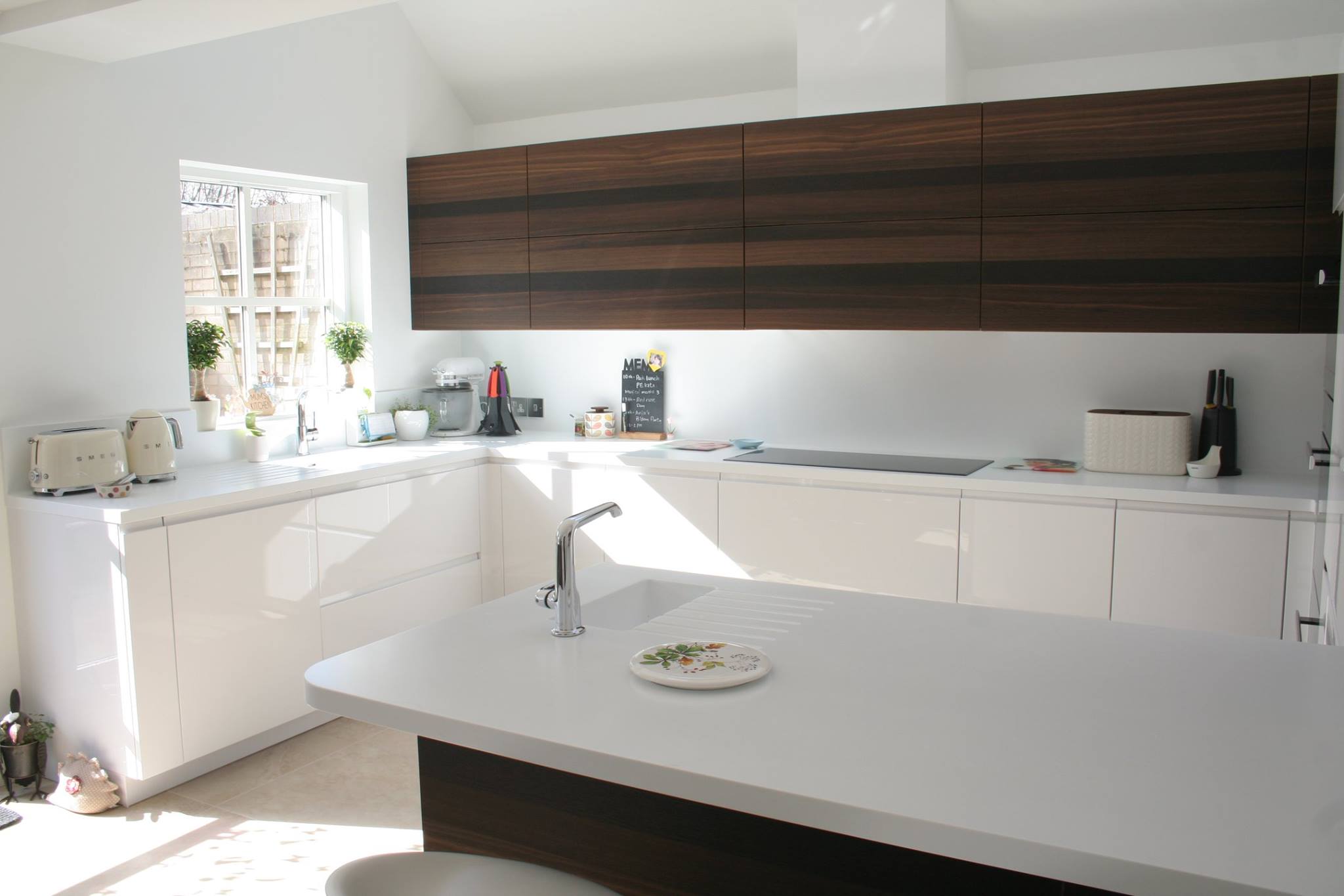 Solo in high gloss white, with smoked oak — a Rational kitchen by Kitchensmiths, with corian worktops (photograph 2 of 3)