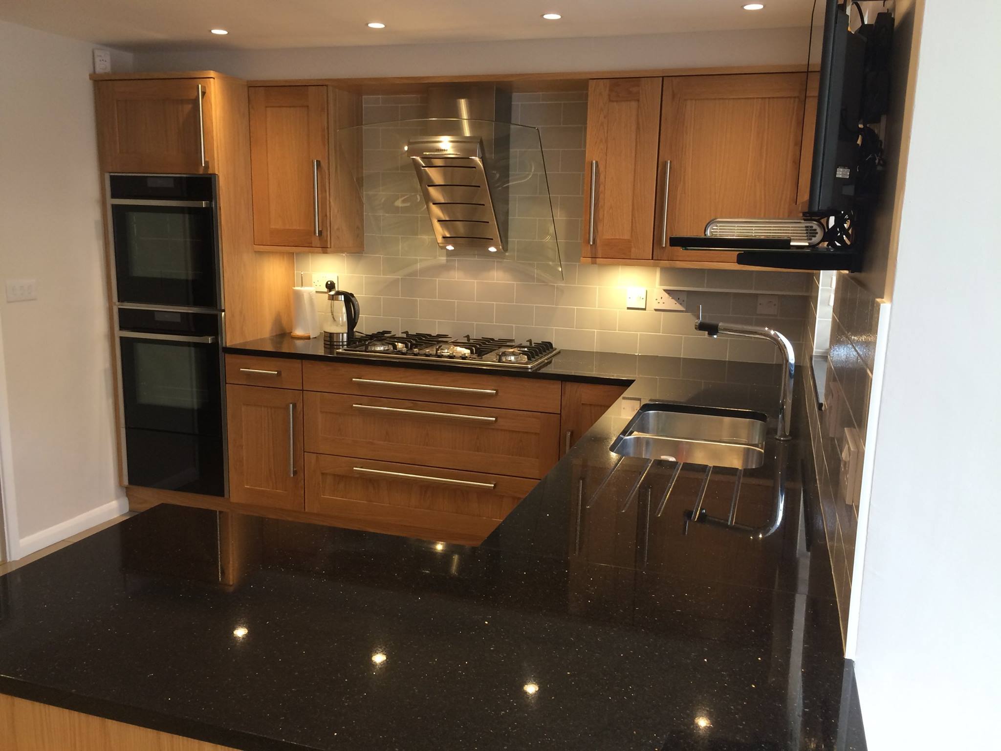 Aspen in light oak, under Star Galaxy — a Stoneham kitchen by Kitchensmiths (photograph 1 of 4)