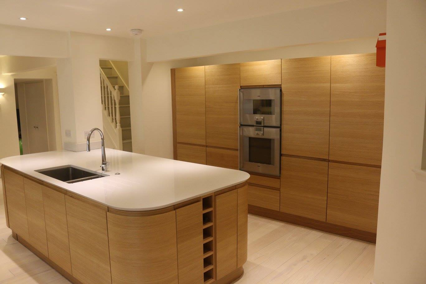 Flow in light oak — a Stoneham kitchen by Kitchensmiths, with silestone worktops (photograph 1 of 7)