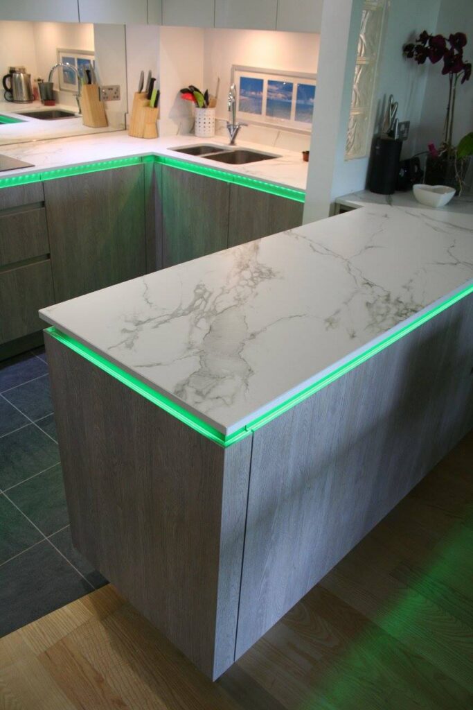 TIO, with Dekton Aura and feature lighting — a kitchen by Kitchensmiths, with dekton Aura worktops (photograph 2 of 5)