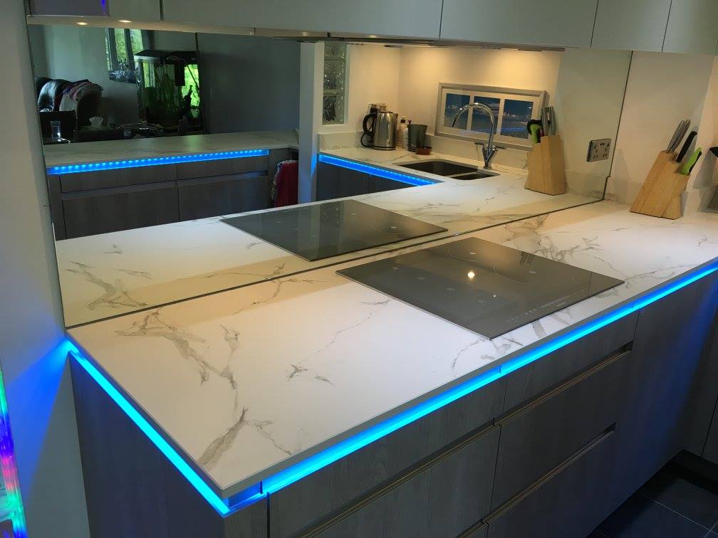 TIO, with Dekton Aura and feature lighting — a kitchen by Kitchensmiths, with dekton Aura worktops (photograph 3 of 5)