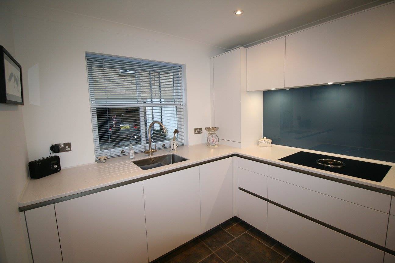 A sleek look for a small kitchen — a Rational kitchen by Kitchensmiths, with corian Everest worktops (photograph 1 of 2)
