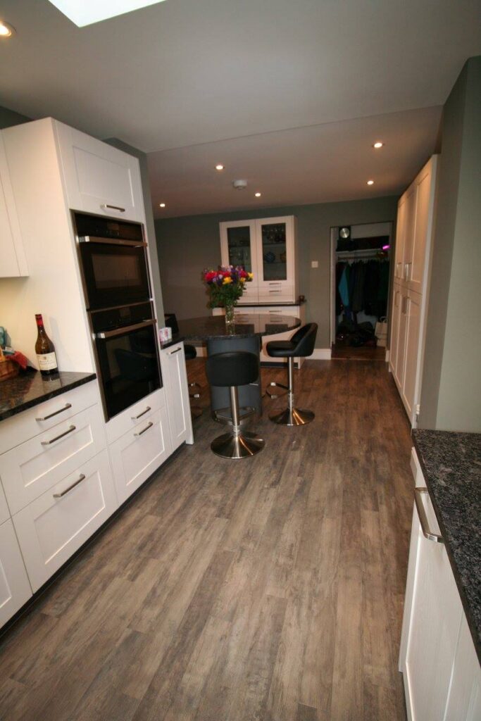 White shaker, steel grey granite — a Störmer kitchen by Kitchensmiths (photograph 3 of 7)