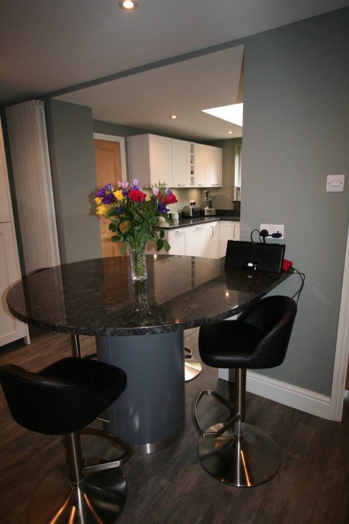 White shaker, steel grey granite — a Störmer kitchen by Kitchensmiths (photograph 5 of 7)