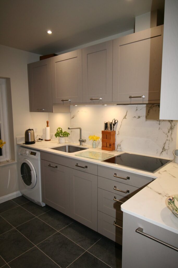 Bristol in Ash Stone Grey — a Störmer kitchen by Kitchensmiths, with dekton Kairos worktops (photograph 1 of 2)
