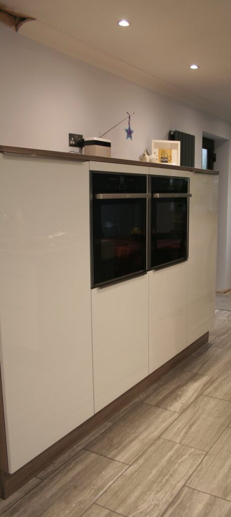 Como High Gloss White, with dark oak — a Störmer kitchen by Kitchensmiths, with oak worktops (photograph 4 of 8)