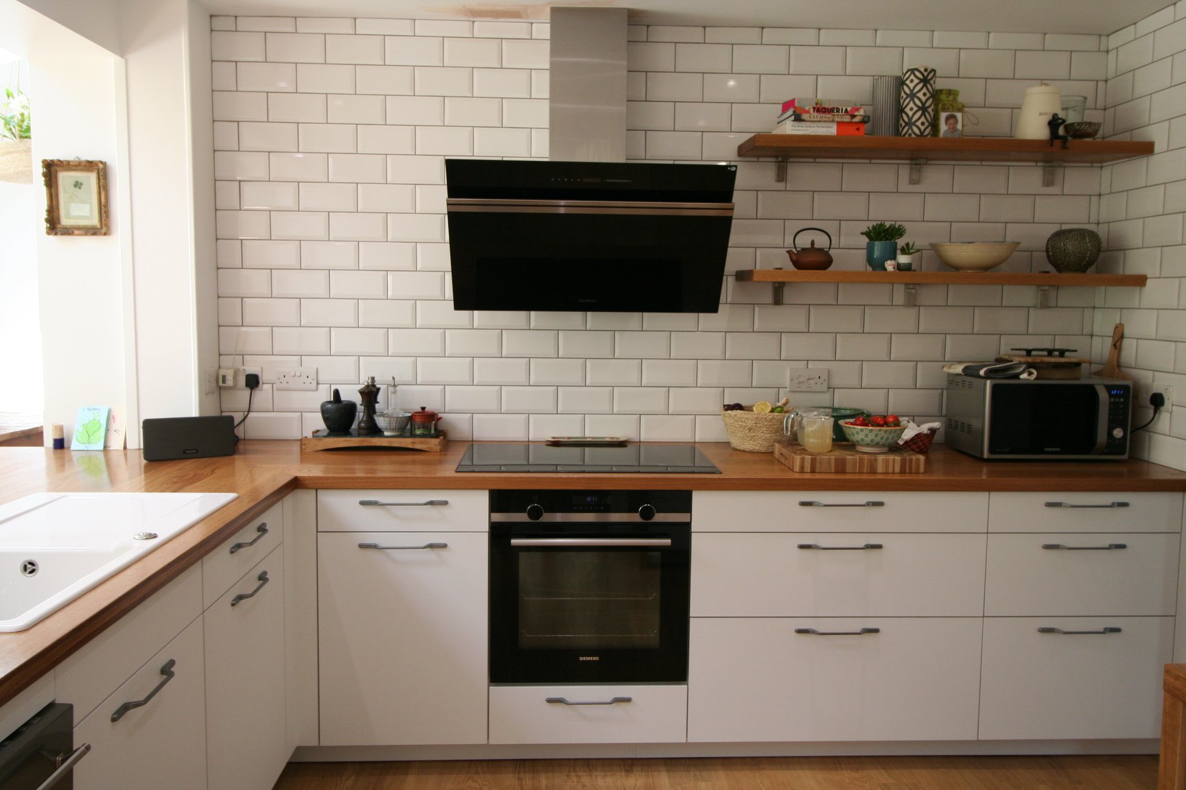 Porcelain White, with a traditional nod — a Rational kitchen by Kitchensmiths, with oak worktops (photograph 3 of 8)