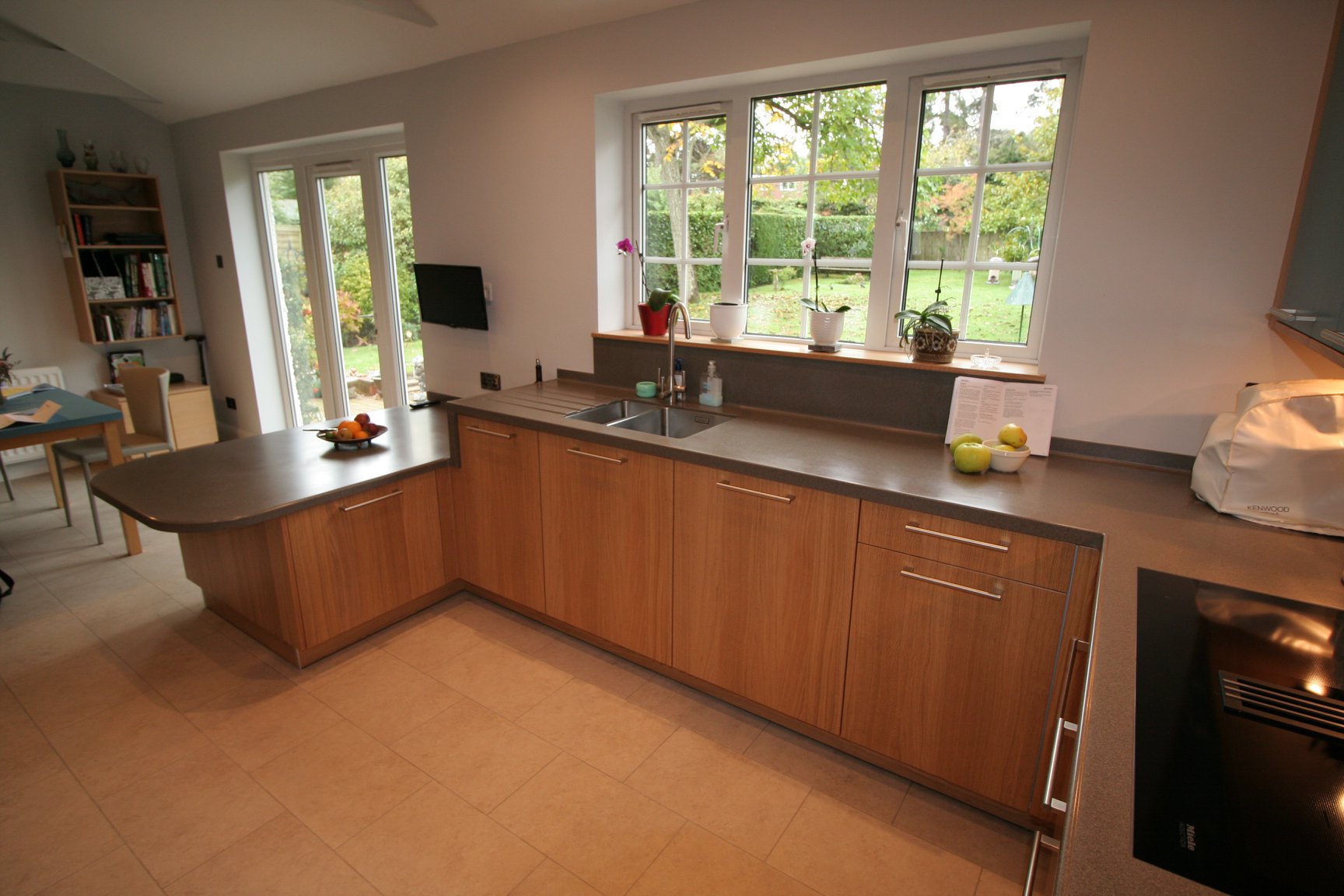Bookmatched light oak and matt teal — a BAX kitchen by Kitchensmiths, with corian worktops (photograph 1 of 3)