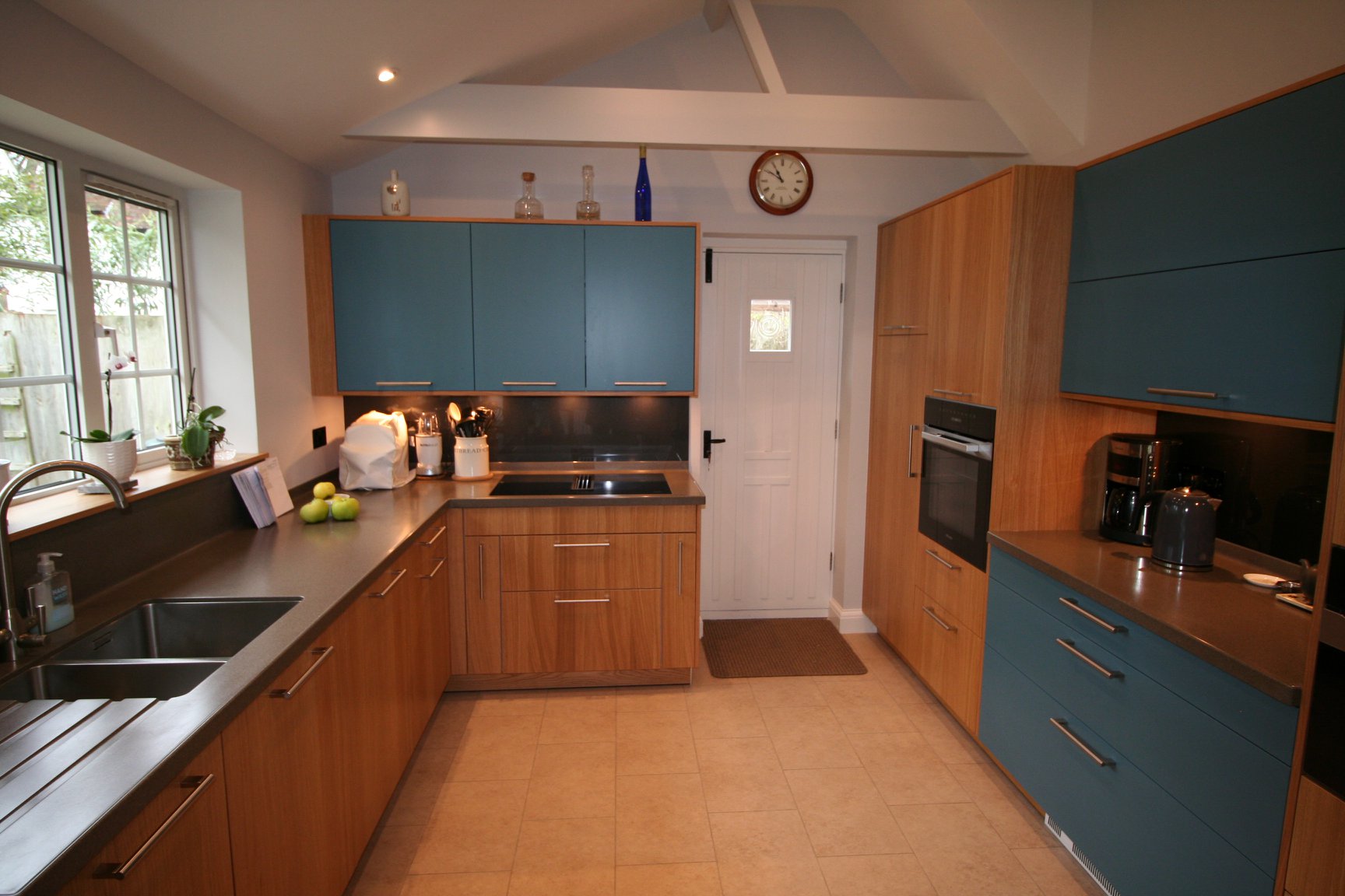 Bookmatched light oak and matt teal — a BAX kitchen by Kitchensmiths, with corian worktops (photograph 2 of 3)