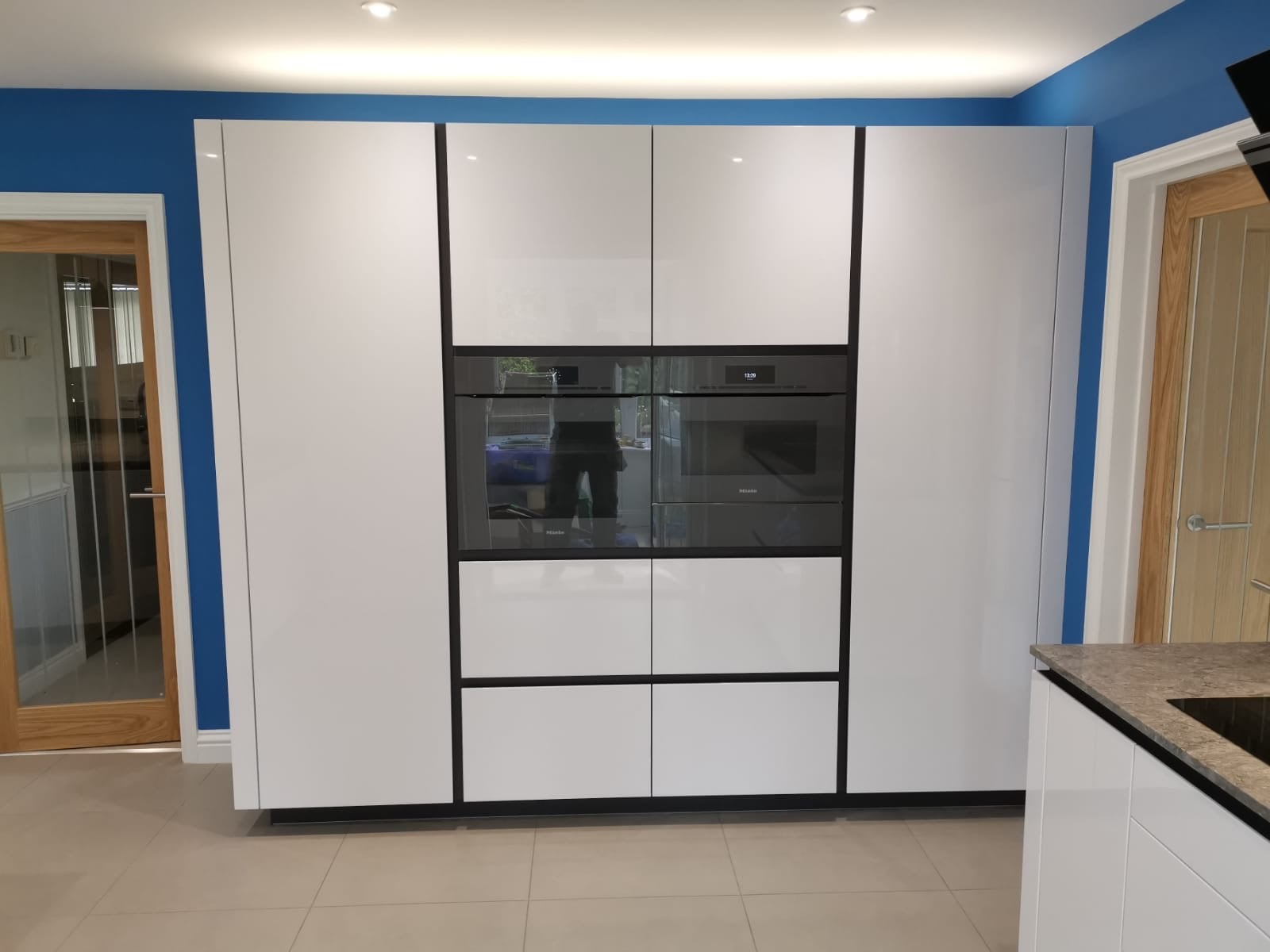 White high gloss TIO — a Rational kitchen by Kitchensmiths, with caesarstone worktops (photograph 2 of 4)