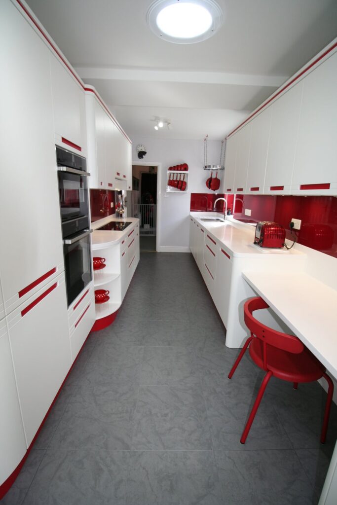 Red stripes and curves, 1950s futurism — a Stoneham kitchen by Kitchensmiths, with corian worktops (photograph 3 of 3)