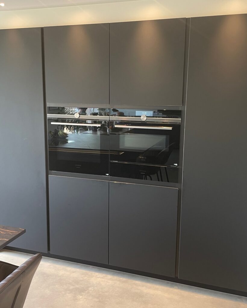 TIO handleless in a bespoke Cambridge build — a Rational kitchen by Kitchensmiths, with dekton Laurent worktops (photograph 5 of 6)
