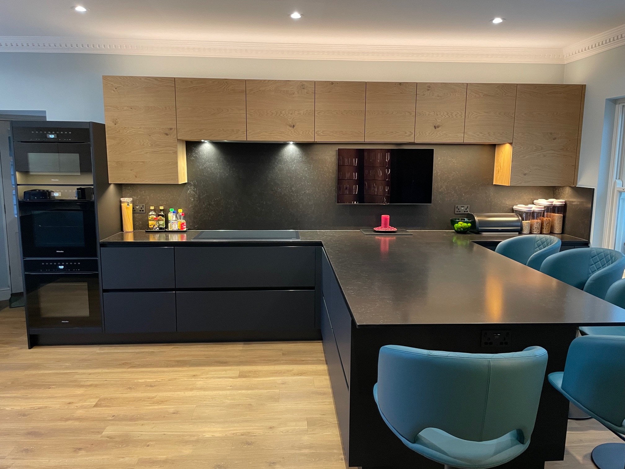 Fenix black and bookmatched oak — a Sachsenküchen kitchen by Kitchensmiths, with quartz worktops (photograph 1 of 5)