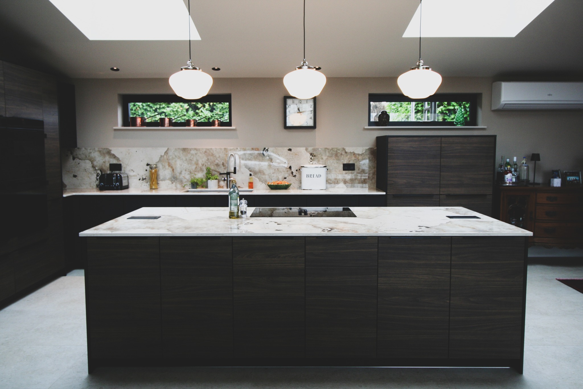 Walnut and black super-matt — a kitchen by Kitchensmiths, with dekton Khalo worktops (photograph 1 of 10)