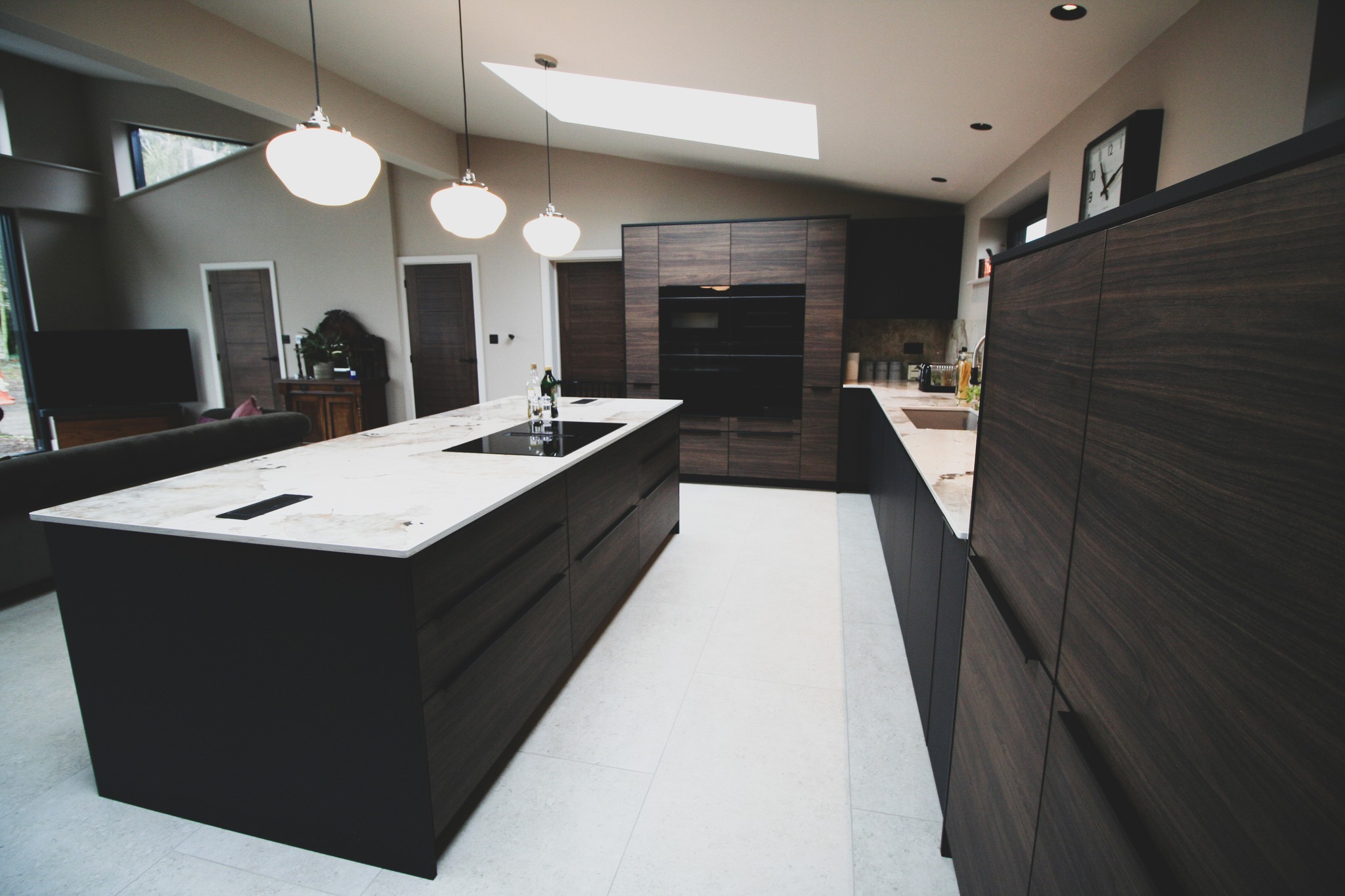 Walnut and black super-matt — a kitchen by Kitchensmiths, with dekton Khalo worktops (photograph 2 of 10)
