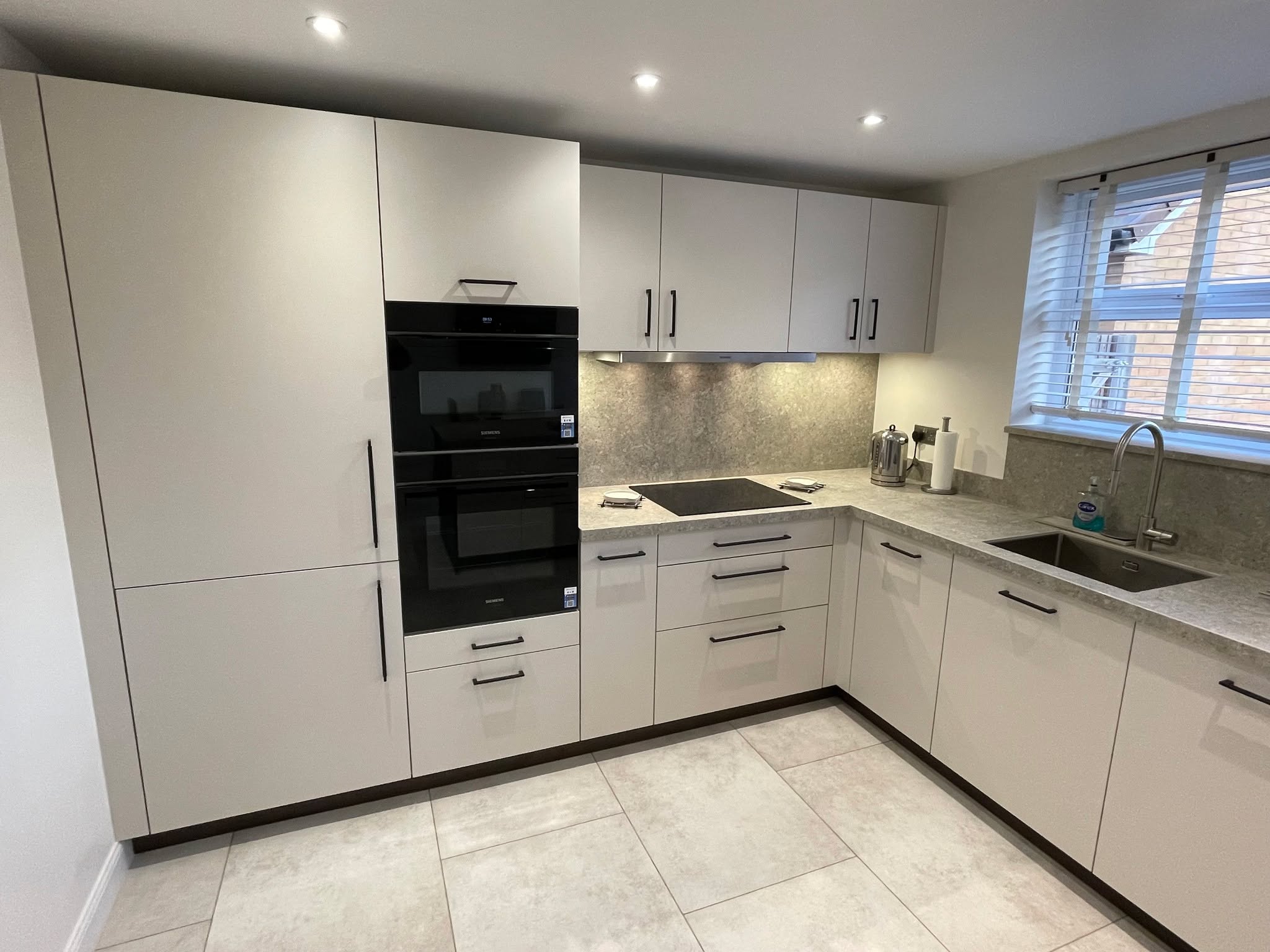 Kitchen and utility, understated — a Sachsenküchen kitchen by Kitchensmiths, with dekton Grigio worktops (photograph 1 of 7)