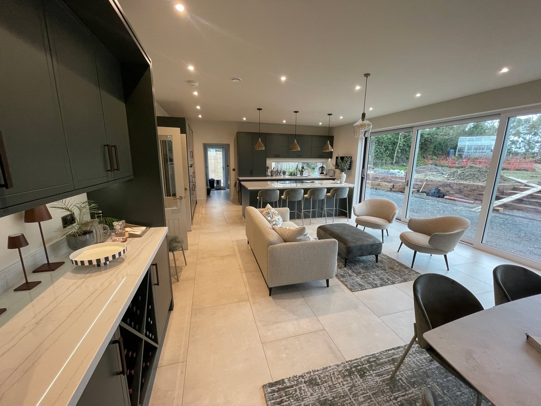 Studio Green, kitchen and living space as one — a Stoneham kitchen by Kitchensmiths, with dekton Limbo worktops (photograph 3 of 6)