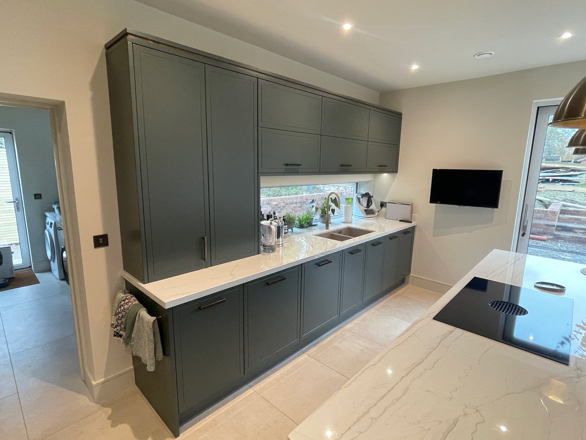 Studio Green, kitchen and living space as one — a Stoneham kitchen by Kitchensmiths, with dekton Limbo worktops (photograph 5 of 6)