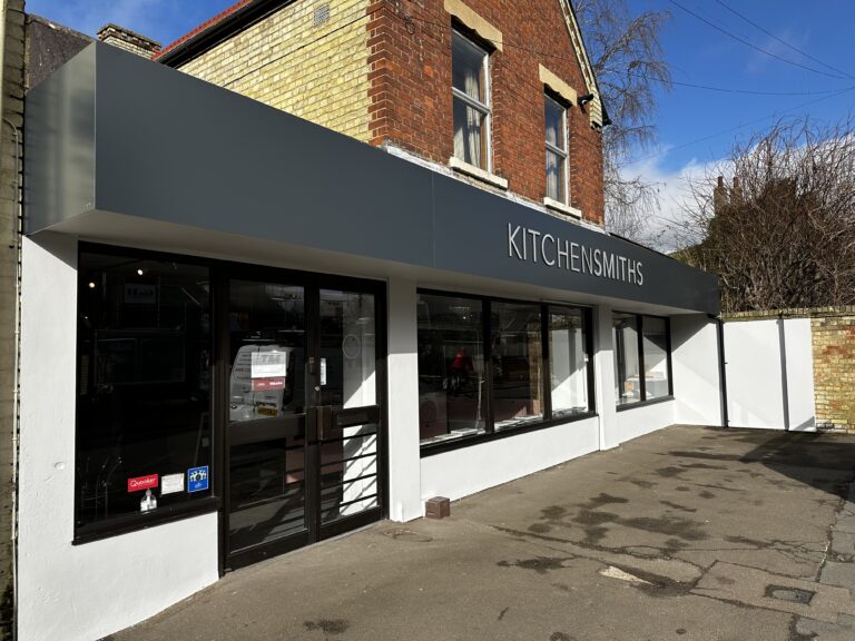 The Kitchensmiths showroom on a bright morning, its name across the fascia above the windows