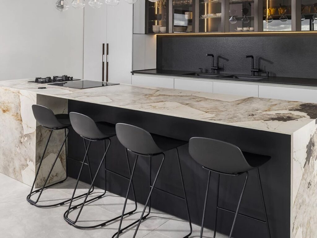 Worktops — a veined stone island with a mitred waterfall edge