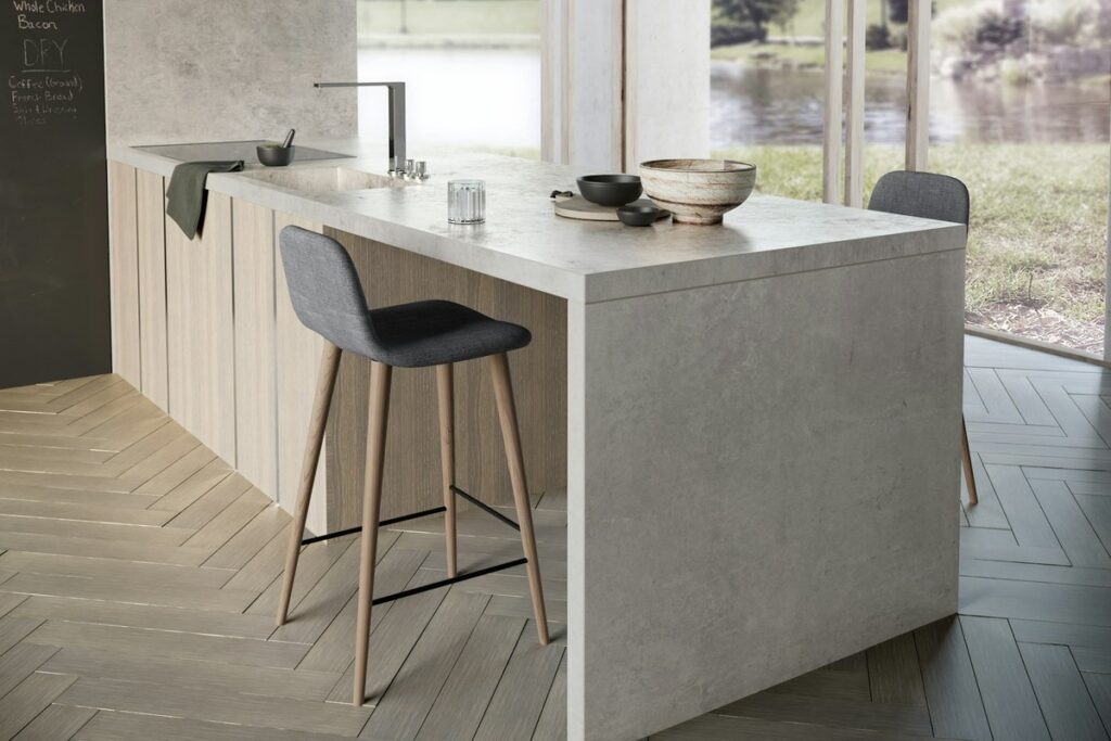 A Dekton Kreta island worktop with a mitred waterfall edge and an integrated sink