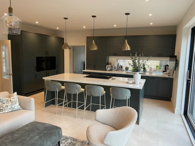 ✨ Step into this breathtaking kitchen and living space, designed to perfection by Alex Baldwin!

From the very first concept to the finished space, this project has been an incredible journey—so much so that our customer was blown away by how realistic the renders were compared to the final result. Scroll through the photos to see just how seamlessly the vision was brought to life!

Here’s what makes this kitchen truly exceptional:
- @stonehamkitchens Inscribe lacquered doors in Studio Green, beautifully accented with custom bronze inlays, adding depth and elegance to the cabinetry.
- A dedicated bar area featuring a stylish cruciform wine rack, perfect for entertaining in style.
- @dektonbycosentino Limbo worktops, built up to a striking 40mm, delivering both durability and a beautifully natural aesthetic.
- A @franke_uk sleek brass tap, bringing a warm, sophisticated accent to the space.
-A premium combination of @siemenshomeuk Studioline, @miele and @boracookingsystems appliances, ensuring seamless functionality with a sleek, modern finish.

With its stunning blend of textures, warm tones, and a seamless indoor-outdoor connection, this space is the epitome of luxury meets practicality. We’re absolutely thrilled with how this vision has come to life—what do you think? Could you see yourself entertaining here? 🍷✨

📸 Swipe to see the incredible transformation from render to reality!

#Kitchensmiths #DreamKitchen #LuxuryLiving #StonehamKitchens #Dekton #SiemensStudioLine #Miele #Bora #Franke #KitchenGoals #KitchenInspiration #FromRenderToReality