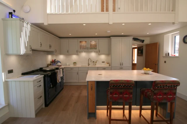✨ A Stunning Shaker-Style Kitchen in a Beautiful Rural Setting ✨

Designed and overseen by Clare, this breathtaking kitchen is set within a converted stable block, blending timeless tradition with modern functionality.

The heart of the space is the family-sized Aga, framed by Stoneham Edwardian cabinetry in a soft Dove Grey, creating a calm and inviting atmosphere. In contrast, the striking Aegean Blue island, accented with light oak details, adds a touch of drama—perfect for both everyday family life and elegant entertaining.

🔥 Key design highlights:

✔ Stoneham Edwardian door style cabinetry in Dove Grey & Aegean Blue from @StonehamKitchens —the perfect balance of classic charm and contemporary function.

✔ Siemens A-Cool three-door fridge-freezer with a built-in ice-maker, from @SiemensHomeUK, offering ample space for family meal prep.

✔ A wide Aga with an induction module, framed by wall units housing a custom-made 1400mm-wide extractor from @westinhoods, the cooker hood specialists.

✔ Glazed wall units that echo the elegant shape above the undermount Blanco Villae Farmhouse double sink from @ukblanco, paired with a Quooker Flex boiling tap from @quookeruk.

✔ Luna Bianco worktops and wall panelling by @CRLStone, providing an easy-clean, softly clouded surface that is both durable and stunning.

The large island isn’t just a showstopper—it’s the centrepiece for entertaining, family meal prep, and the best spot for spreading out the Sunday papers.

What do you think? Could you picture yourself cooking here? 🍽️✨

Huge thanks to our amazing fitting team for bringing this vision to life!

#Kitchensmiths #DreamKitchen #ShakerStyle #LuxuryLiving #StonehamKitchens #Aga #SiemensStudioLine #Westin #Blanco #Quooker #CRLStone #KitchenGoals #KitchenInspiration